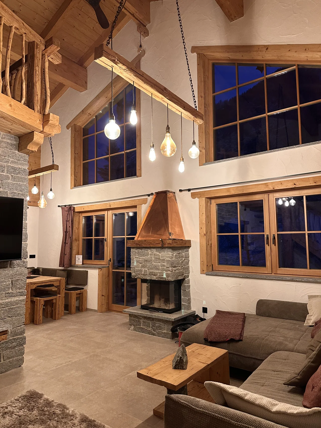 Graue Couch und Kamin im Chalet am Bachl, aufgenommen im Januar 2026