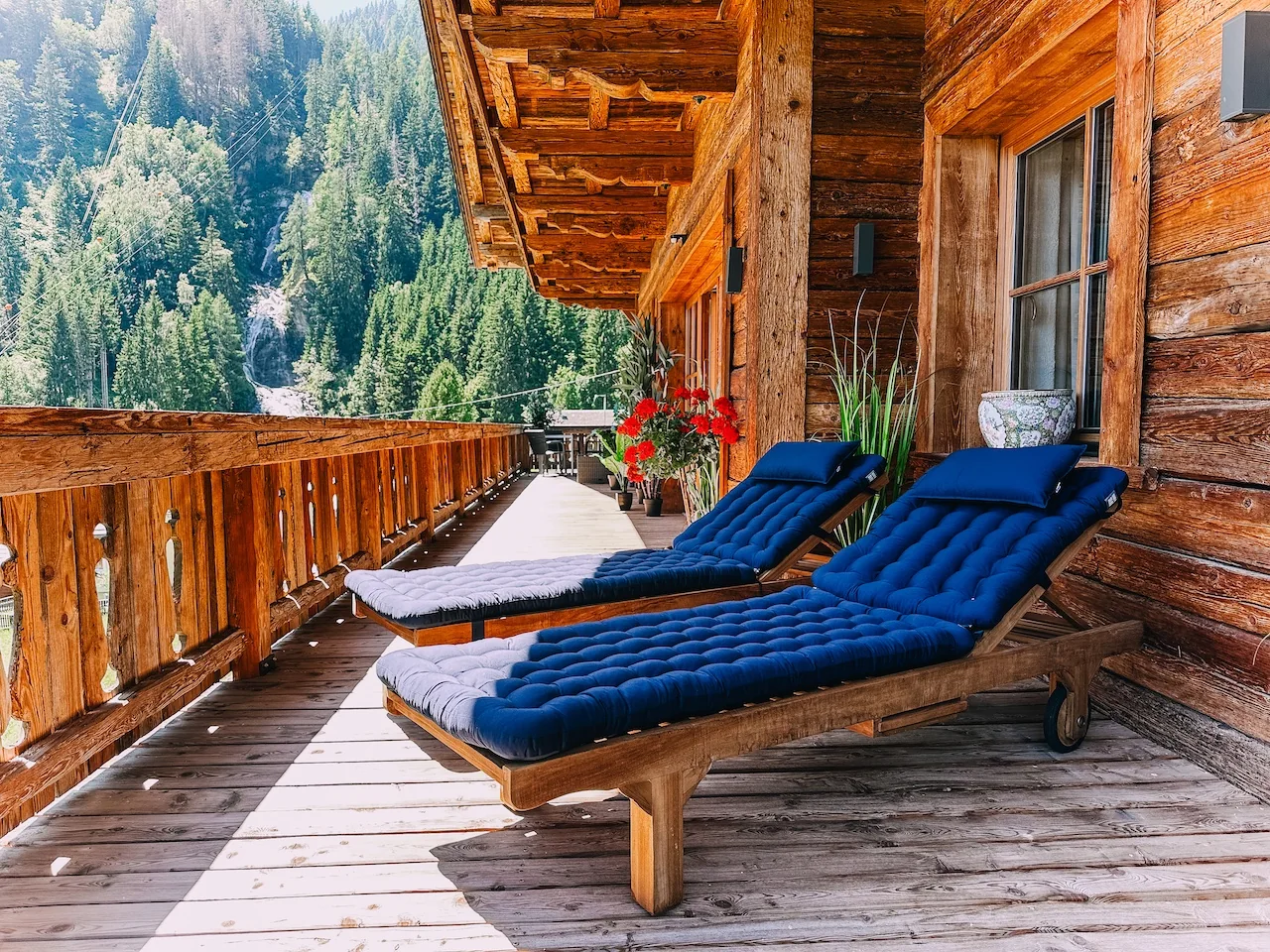 Zwei Liegestühle auf der überdachten Holzterrasse des Studios Wasserfall